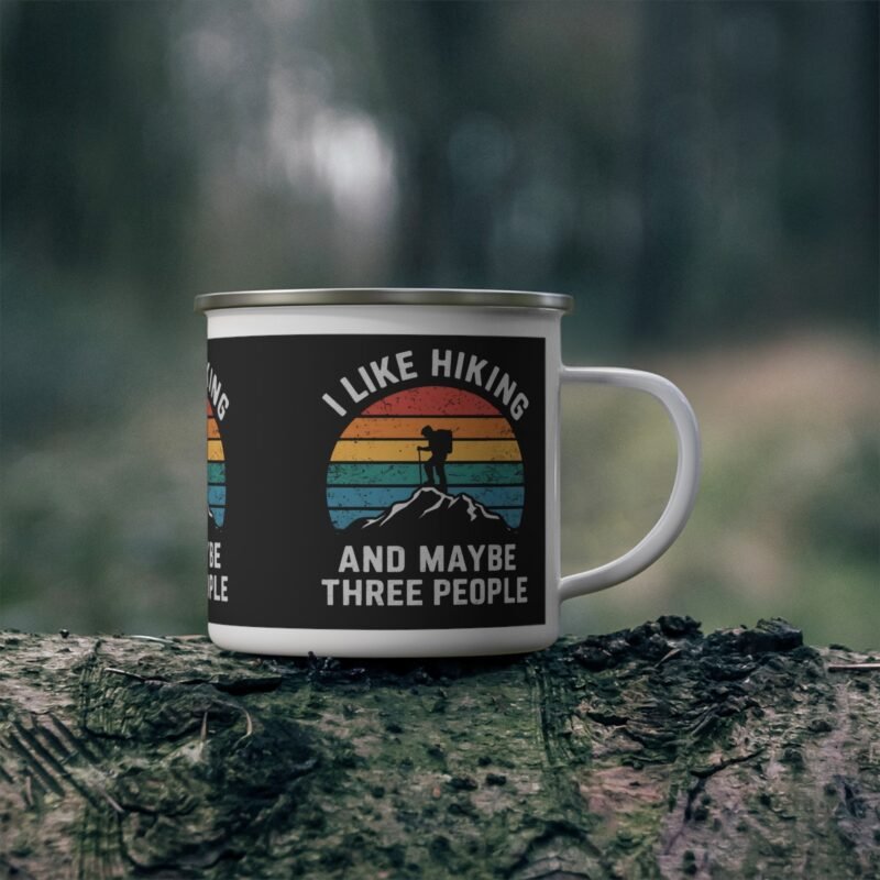 White enamel hiking mug with retro sunset and funny “I Like Hiking and Maybe Three People” quote design